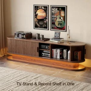 Curved walnut TV stand with a built-in record shelf, vinyl player on the left, stacked books and decorative items, and framed posters above.