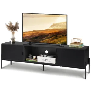 Black entertainment console with a large flat-screen TV, a glass vase with dried plants on the left, and books with decorative items on the right.