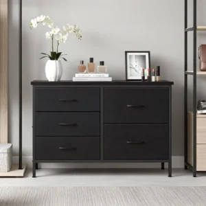 Black dresser with six drawers topped by a white orchid vase, perfume bottles, a framed photo, and makeup items on the surface.